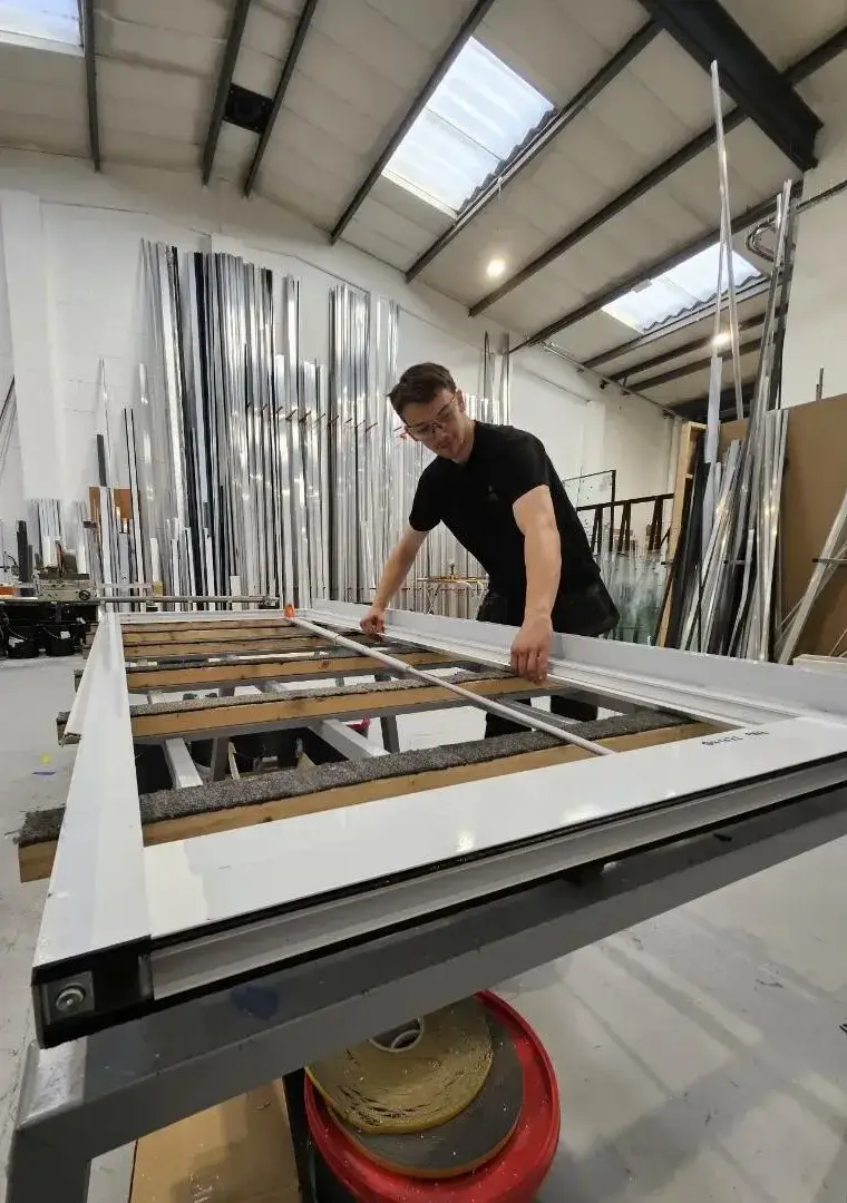 Commercial aluminium door frame being measured and checked in the Kingsland Fabrications workshop