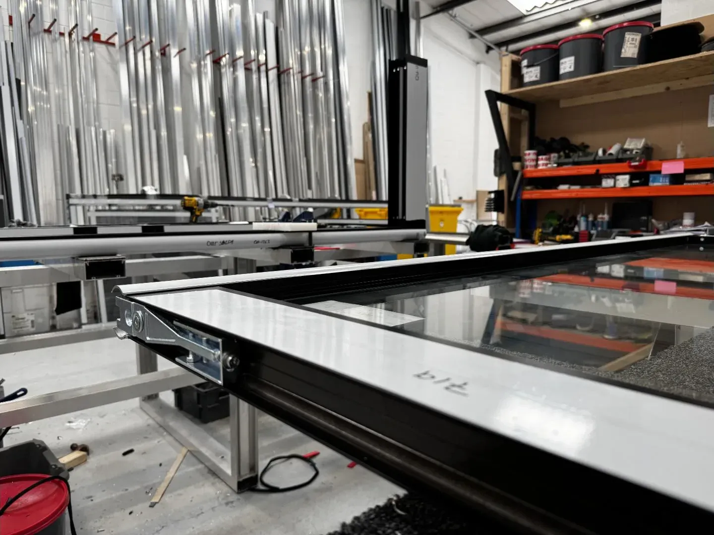 Window frame assembled on jig with hardware being fitted before dispatch